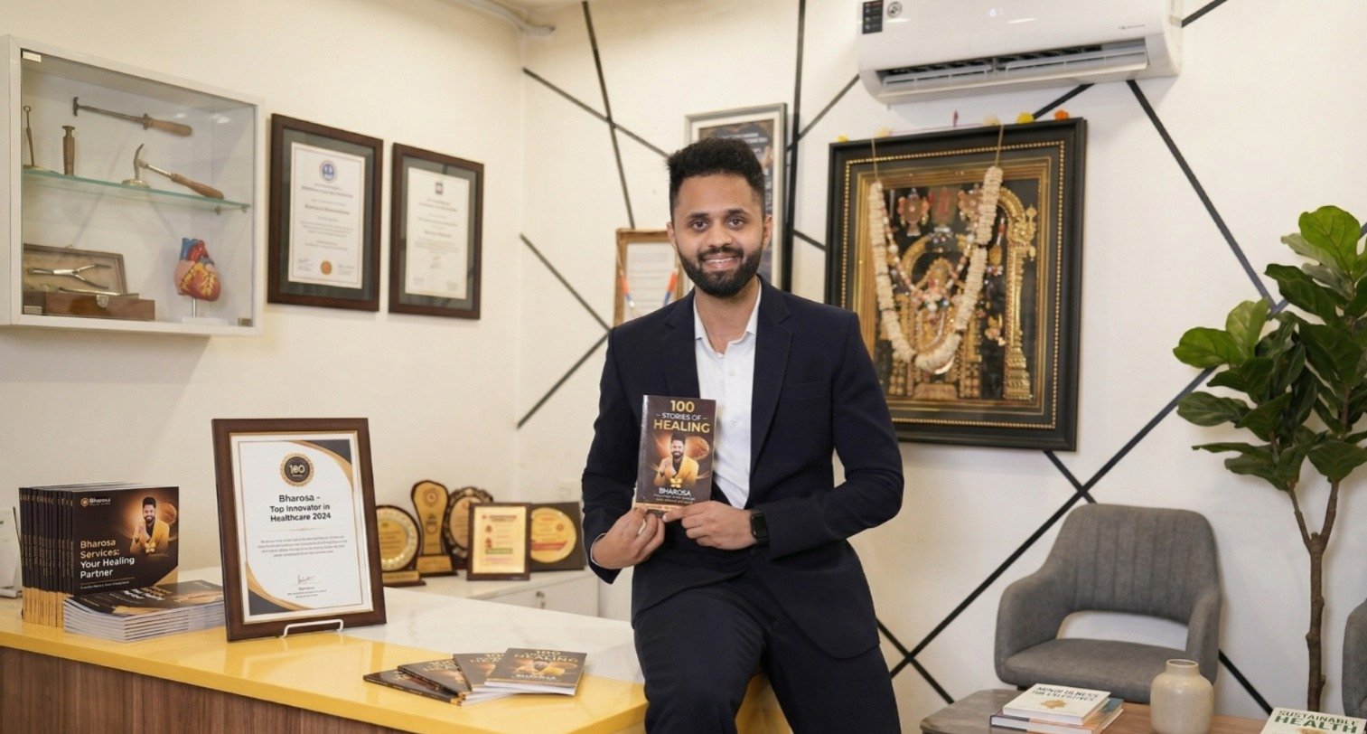 Dr. Uday Kiran holding 100 Stories of Healing